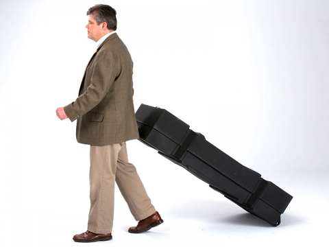 Portable Roto-molded Case with Wheels Being Pulled by Man