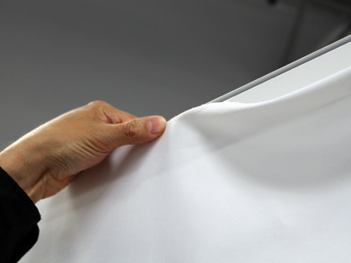 NEXT! 20ft Backlit SEG Inline Pop-up Display SEG Graphic Being Applied